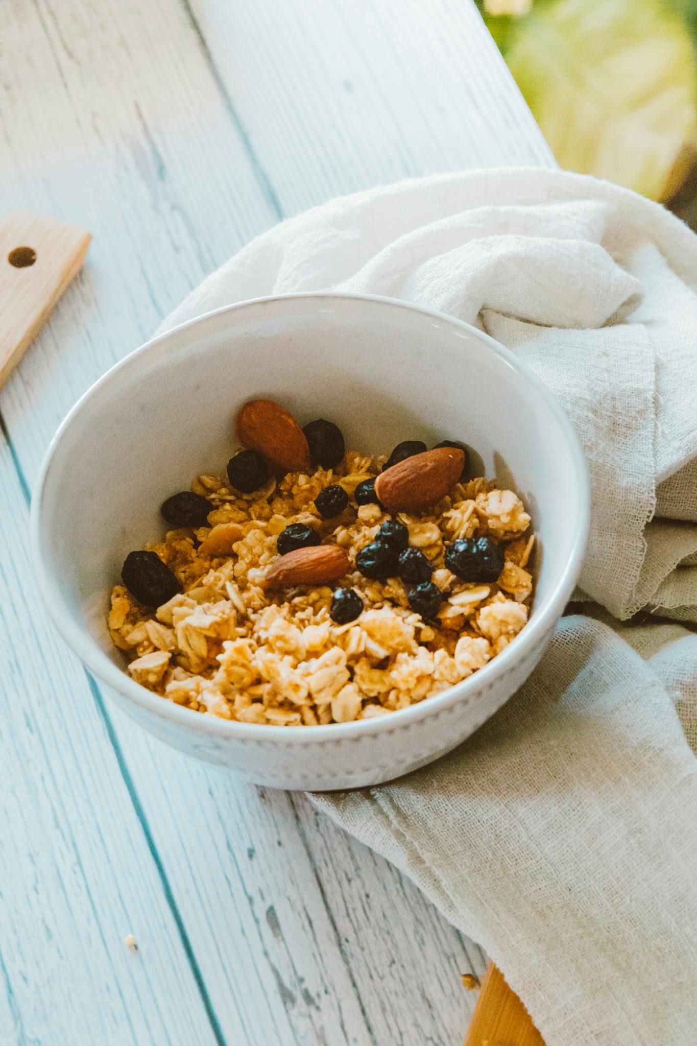 Delicious bowl of granola with almonds and raisins, perfect for a nutritious breakfast.
