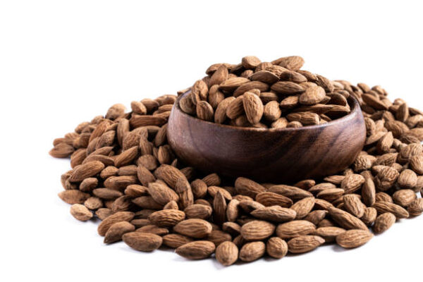 Almonds in wooden bowl isolated on white