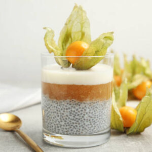 Delicious chia pudding decorated with physalis on light grey table