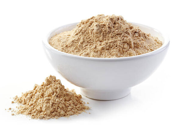 Bowl of maca powder isolated on white