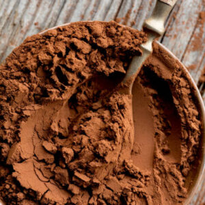 Cocoa powder in bowl with spoon